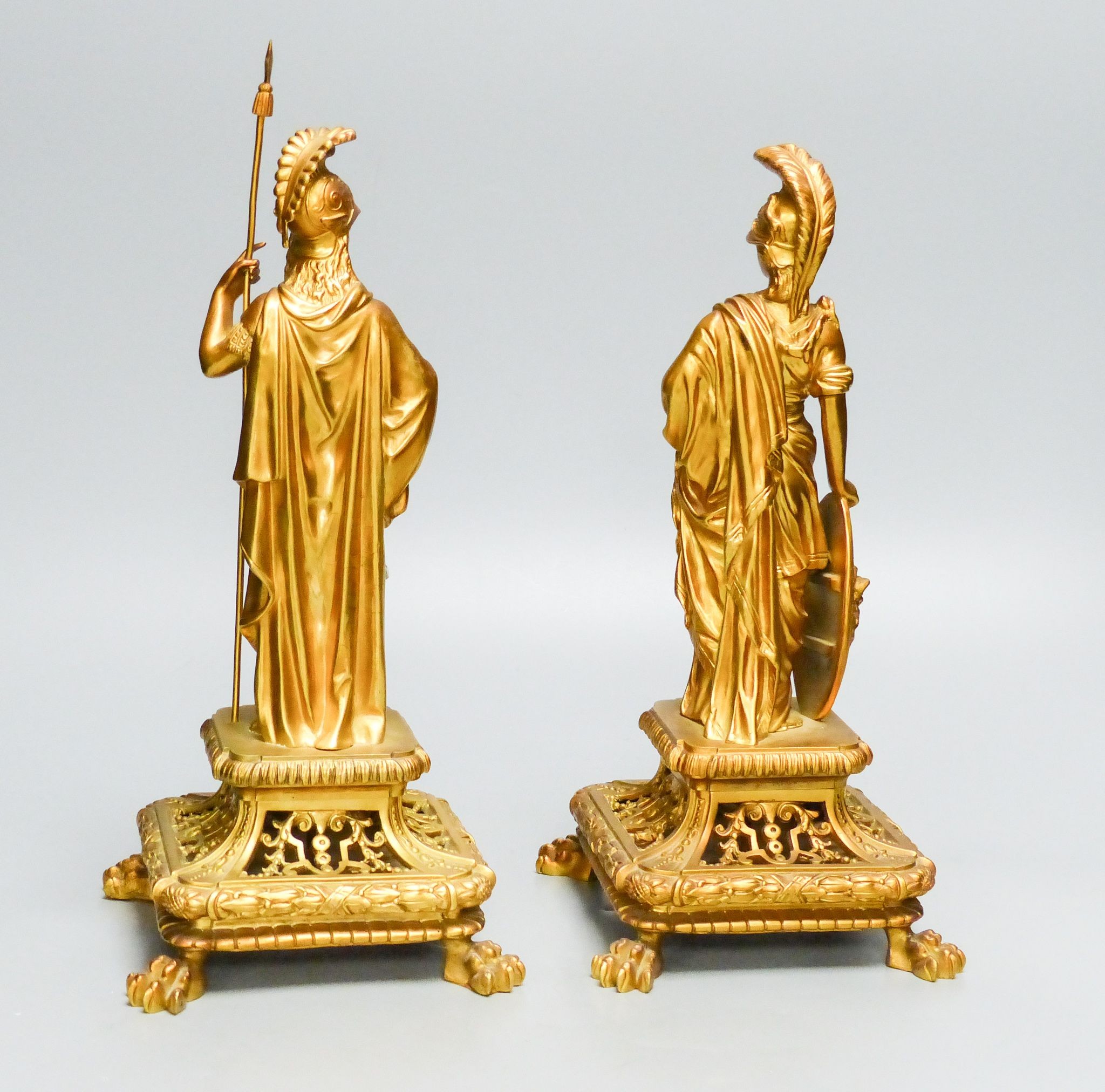 A pair of late 19th century ormolu figures of Roman soldiers, on openwork faces, tallest 32.5 cm